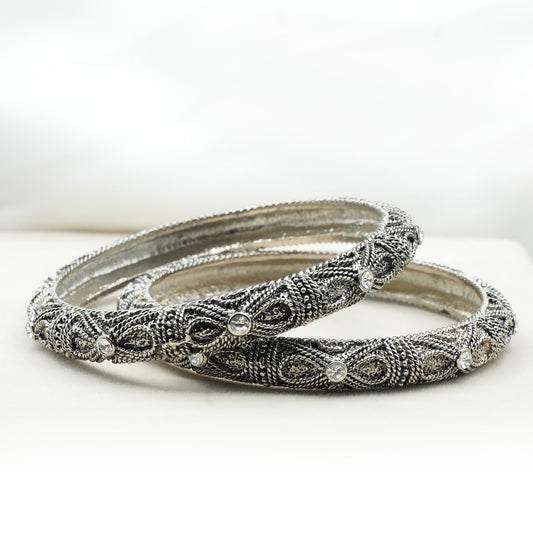 A pair of bangles, crafted from high-quality metal, possibly silver or oxidized gold, giving them a vintage and antique appeal image 1