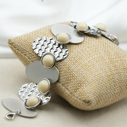A contemporary mix of oval and circular metal elements in alternating textures image 2