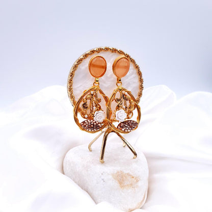 oval-shaped gemstone at the top, followed by a delicate gold frame with decorative swirls, tiny pearls, and a small rose image 2