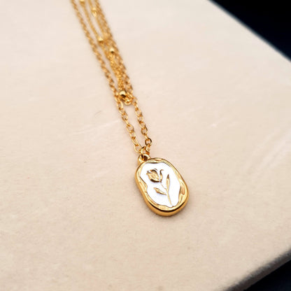 A stunning stainless steel pendant on a golden chain, combining elegance and durability for a timeless look. image 2
