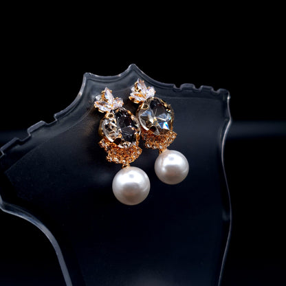 Stunning oval-shaped rhinestone earrings with a graceful pearl for an elegant charm. image 0