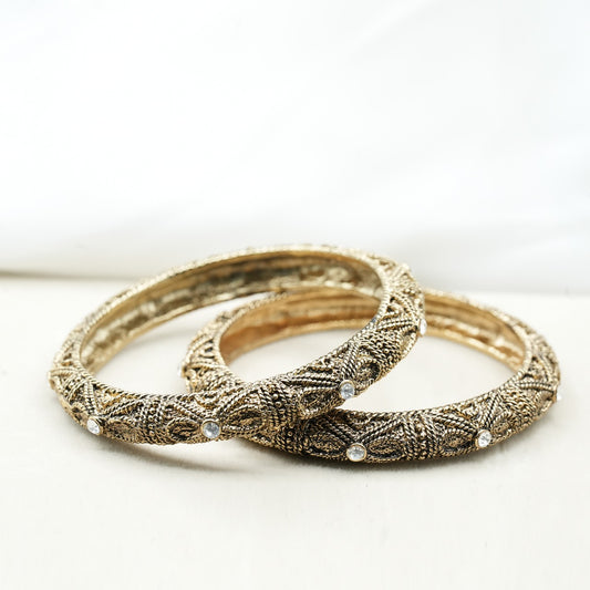 A pair of bangles, crafted from high-quality metal, possibly silver or oxidized gold, giving them a vintage and antique appeal image 0