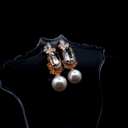 Stunning rhinestone earrings with a graceful drop-down pearl for a timeless and elegant charm.(Silver = 1, Champagne = 1) image 2