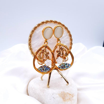 oval-shaped gemstone at the top, followed by a delicate gold frame with decorative swirls, tiny pearls, and a small rose image 3