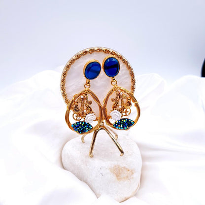 oval-shaped gemstone at the top, followed by a delicate gold frame with decorative swirls, tiny pearls, and a small rose - ROYAL BLUE image