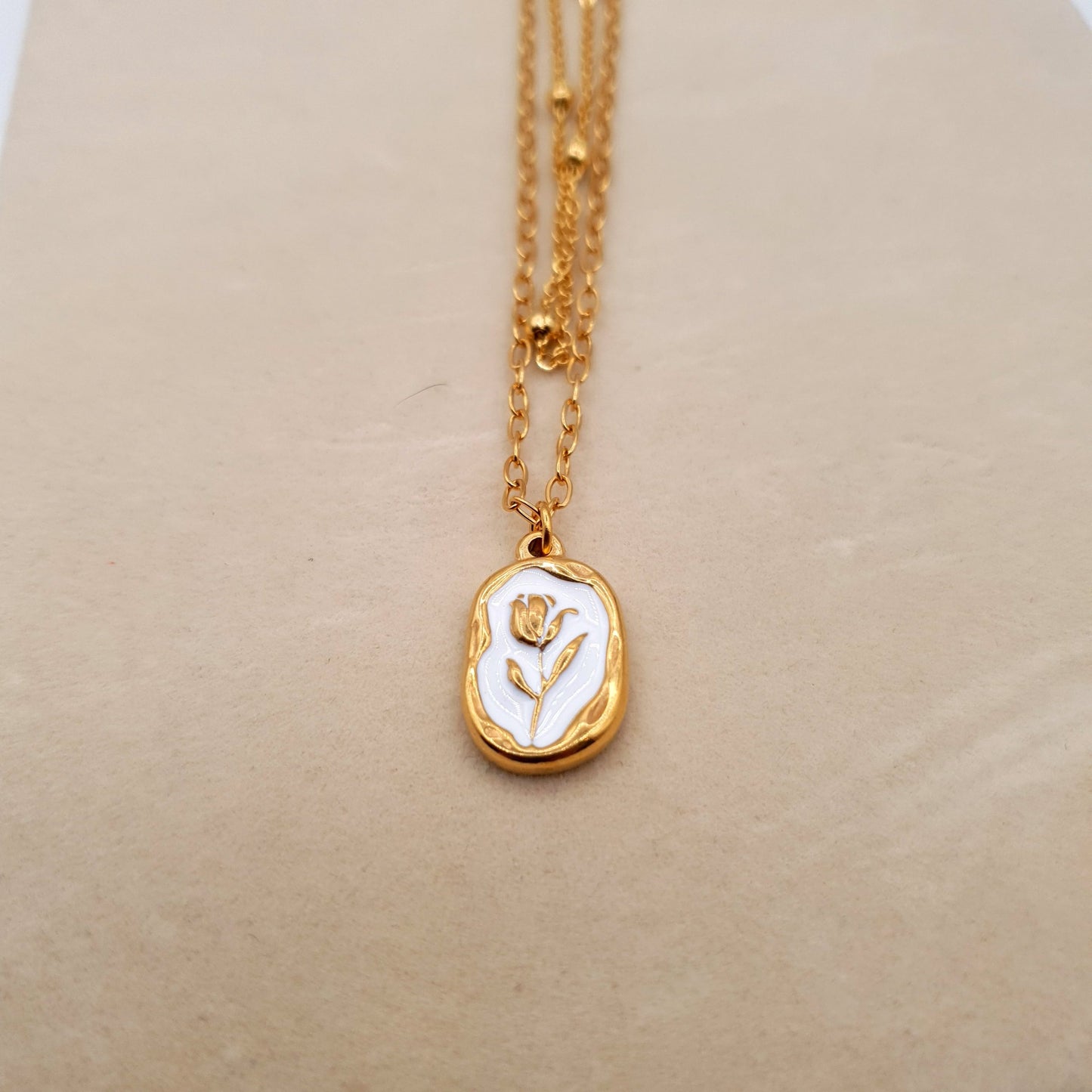 A stunning stainless steel pendant on a golden chain, combining elegance and durability for a timeless look. image 4