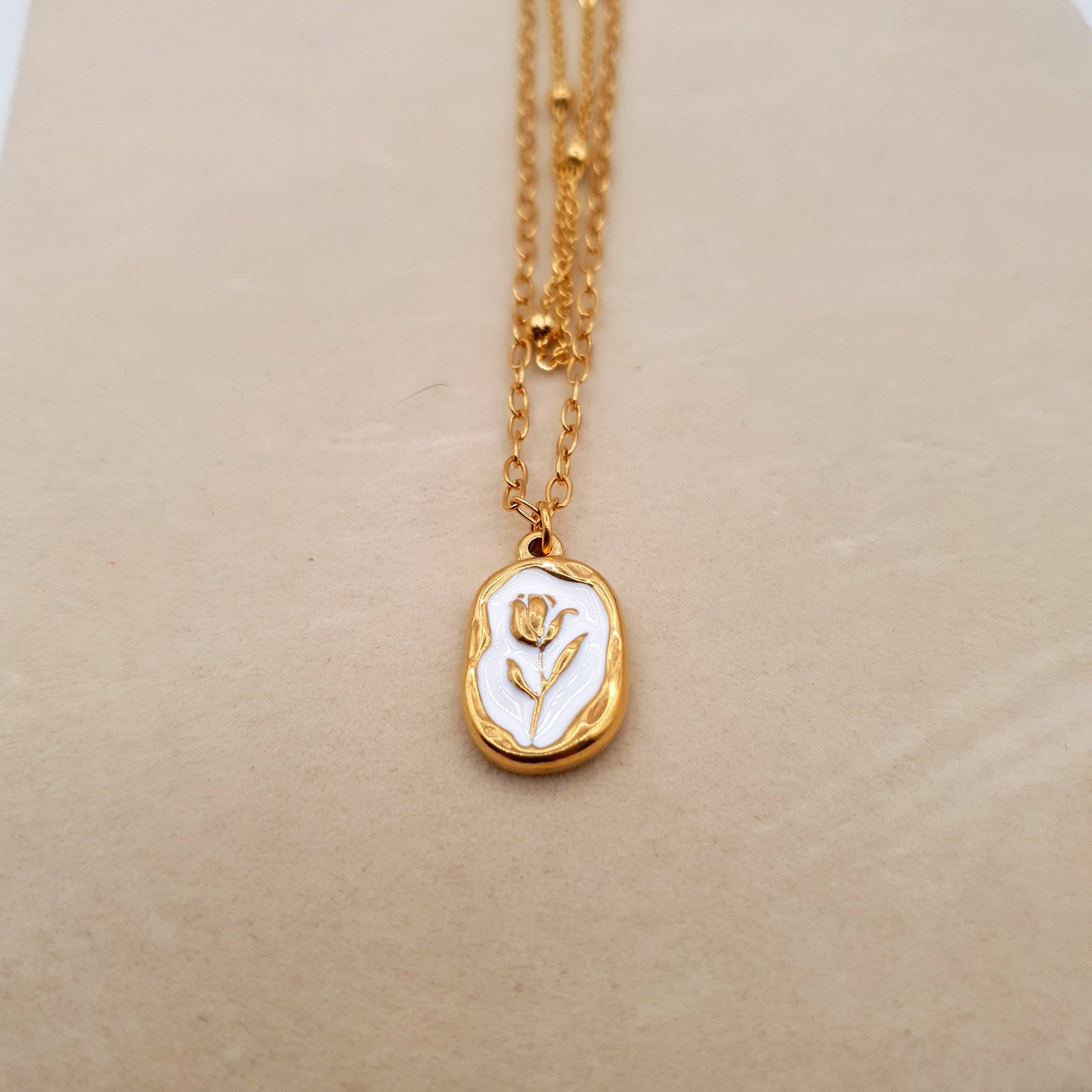 A stunning stainless steel pendant on a golden chain, combining elegance and durability for a timeless look. image 4