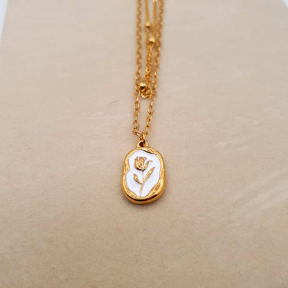 A stunning stainless steel pendant on a golden chain, combining elegance and durability for a timeless look. image 4
