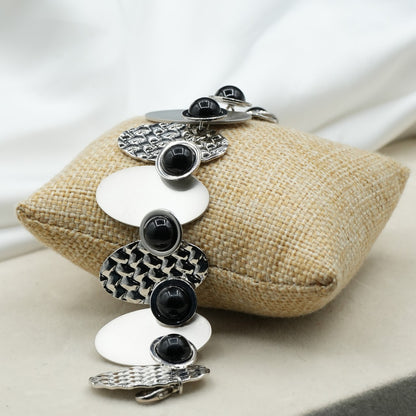 A contemporary mix of oval and circular metal elements in alternating textures image 5