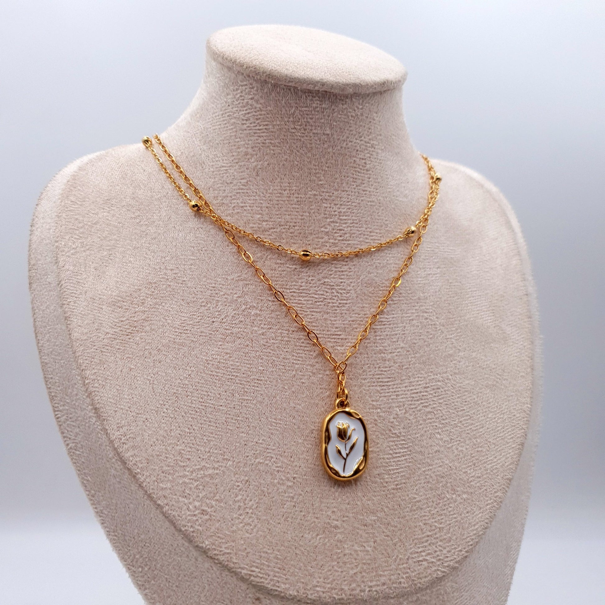A stunning stainless steel pendant on a golden chain, combining elegance and durability for a timeless look. image 5