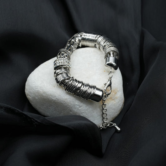 A modern and edgy coiled metal ring structure with a stacked effect, creating depth and texture image 0