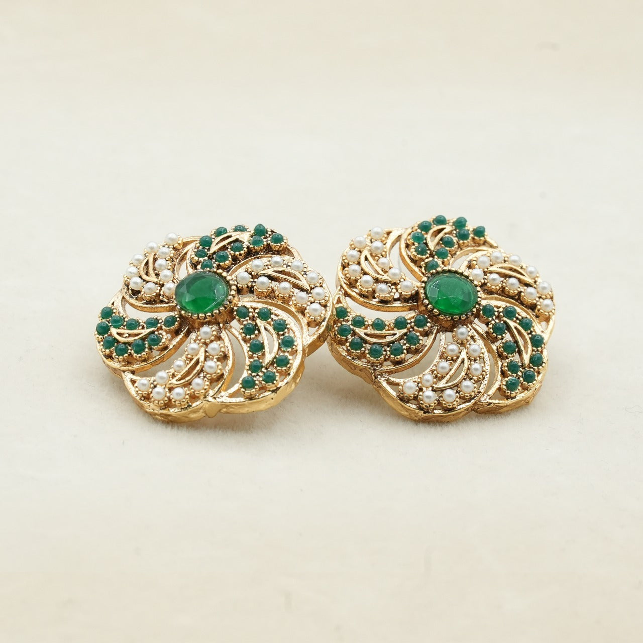 Likely gold-plated metal with a detailed filigree design - Green image