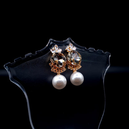 Stunning oval-shaped rhinestone earrings with a graceful pearl for an elegant charm. image 4