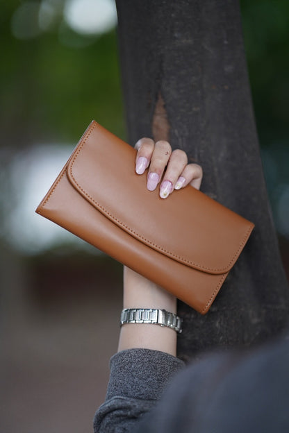 A Stylish and minimalistic genuine leather clutch with a smooth finish and curved flap design, perfect for any occasion image 0