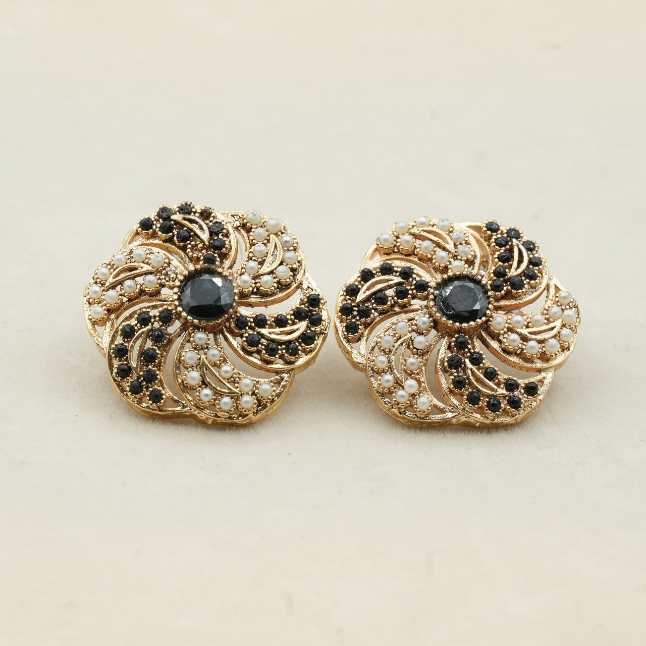 Likely gold-plated metal with a detailed filigree design - Black image