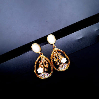 oval-shaped gemstone at the top, followed by a delicate gold frame with decorative swirls, tiny pearls, and a small rose - White image