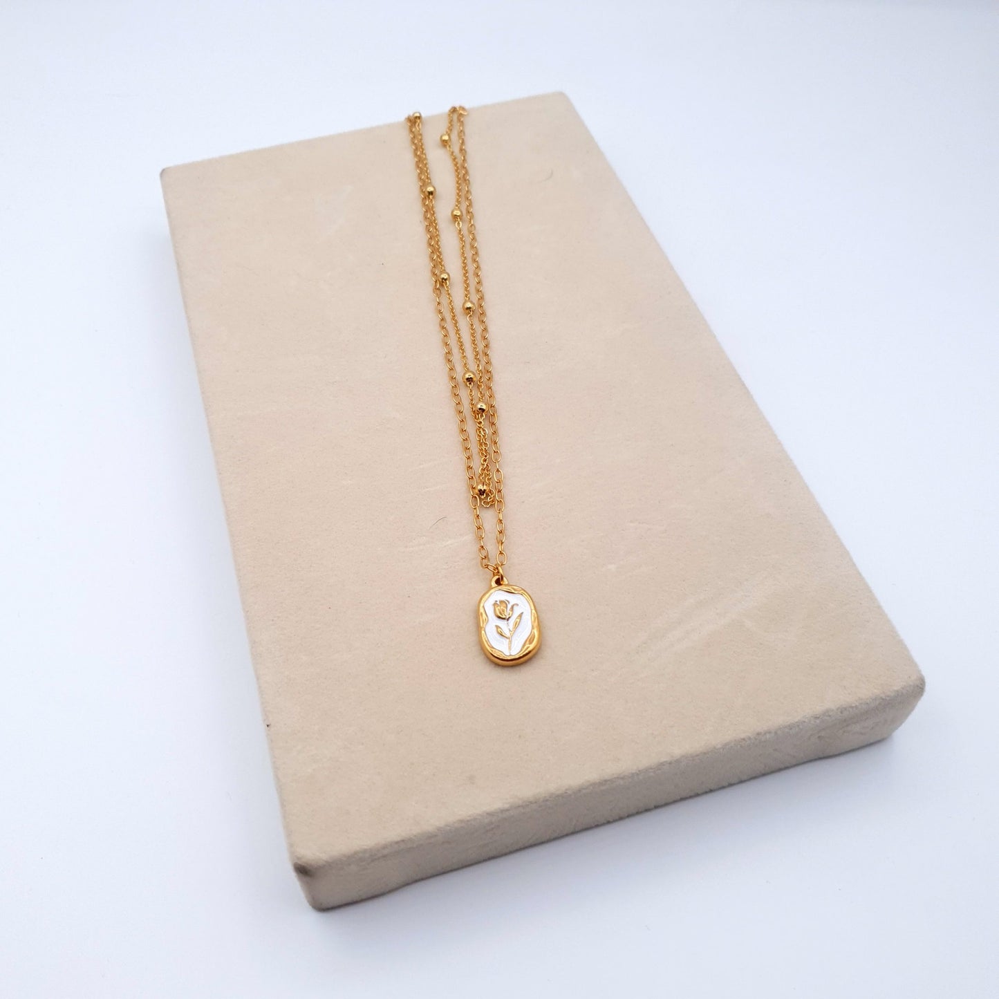 A stunning stainless steel pendant on a golden chain, combining elegance and durability for a timeless look. image 3