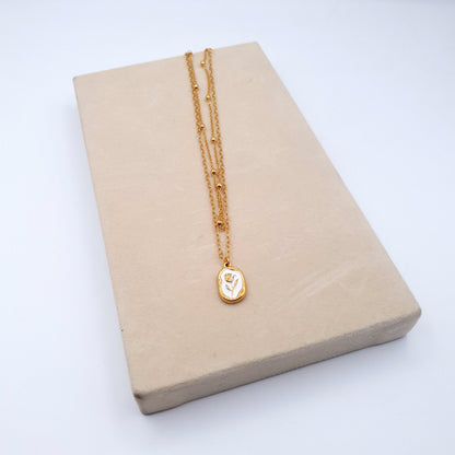 A stunning stainless steel pendant on a golden chain, combining elegance and durability for a timeless look. image 3