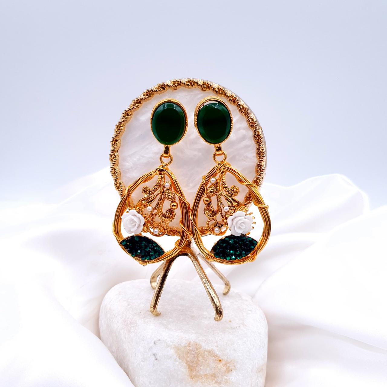 oval-shaped gemstone at the top, followed by a delicate gold frame with decorative swirls, tiny pearls, and a small rose image 0