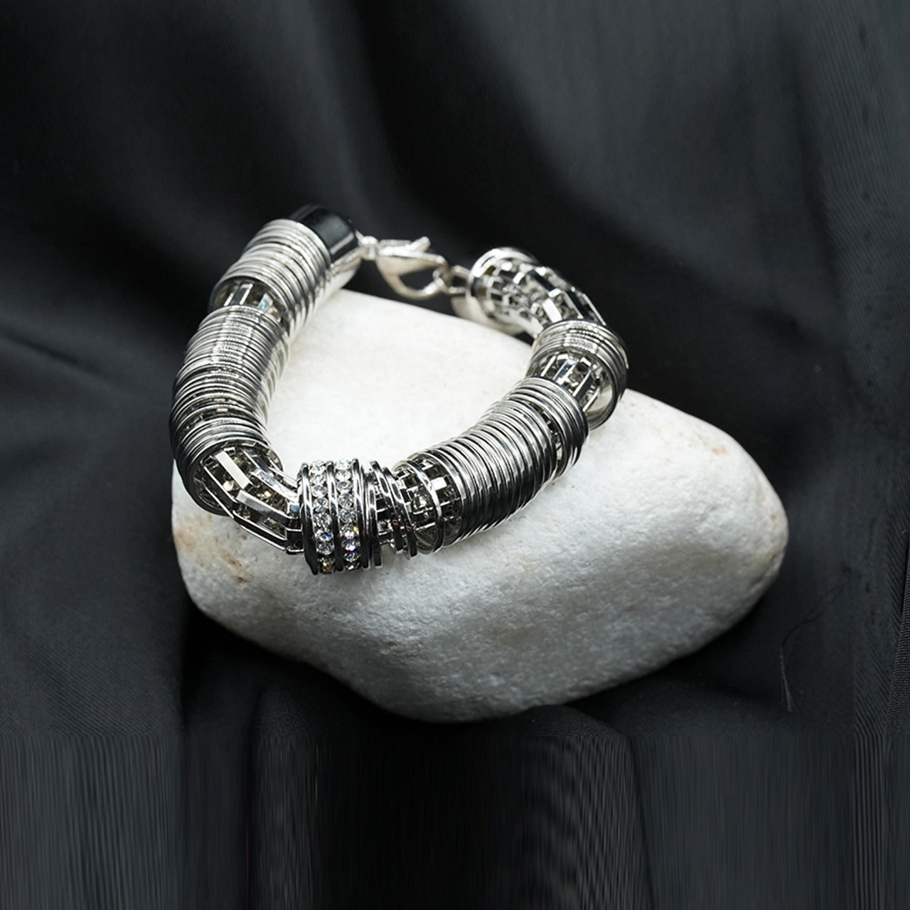 A modern and edgy coiled metal ring structure with a stacked effect, creating depth and texture image 2