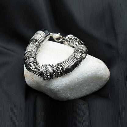 A modern and edgy coiled metal ring structure with a stacked effect, creating depth and texture image 2