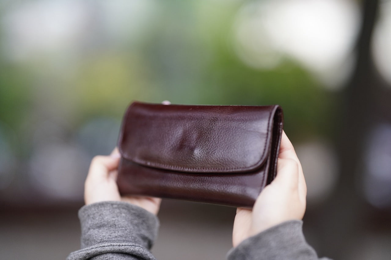 A Stylish and minimalistic genuine leather clutch with a smooth finish and curved flap design, perfect for any occasion image 3