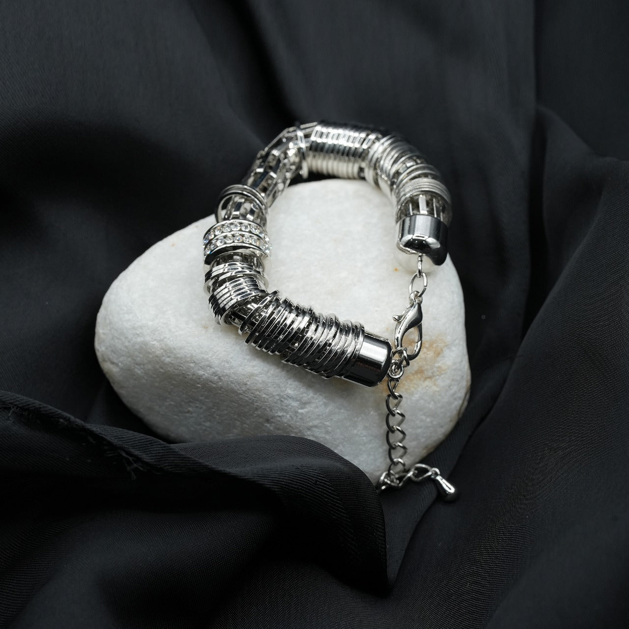 A modern and edgy coiled metal ring structure with a stacked effect, creating depth and texture image 3
