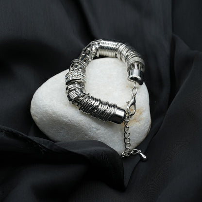 A modern and edgy coiled metal ring structure with a stacked effect, creating depth and texture image 3